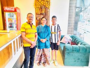 a group of three people standing in a room at Avista Hotel in Amritsar