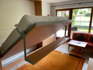 a bunk bed in a living room with a couch at Ferienwohnung Niklas inklusive Bad Hindelang Plus in Bad Hindelang