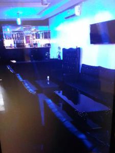 a bar with tables and couches in a room at Koko HOMES LEKKI PHASE 1 in Lagos