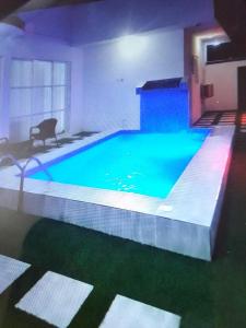 a large swimming pool in a building with a blue pool at Koko HOMES LEKKI PHASE 1 in Lagos
