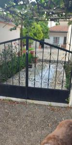 a black gate with a garden behind it at Lambrinis house in Kanallákion