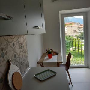 a small kitchen with a table and a window at Casa Fornace in Ala