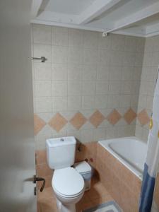 a bathroom with a toilet and a bath tub at Evi's house in Nikiana +16 photos