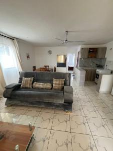 ein Wohnzimmer mit Couch und Küche in der Unterkunft Ariosa Apartments in Mtwapa