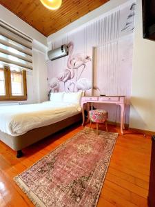 a bedroom with a bed with a pink wall at DIMORA HOTEL in Istanbul