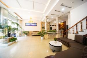 a lobby of a hospital with a couch and a table at CHERRY HOTEL in Da Lat