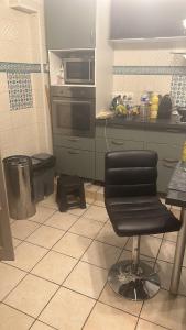 a kitchen with a chair in the middle of a kitchen at Laila in Creil