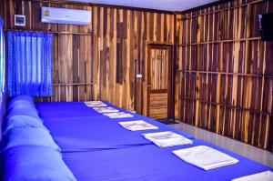 a bedroom with a blue bed with towels on it at Adventure Point Resort By Sali in Kaeng Krachan