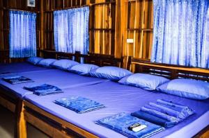 a large blue bed with blue pillows on it at Adventure Point Resort By Sali in Kaeng Krachan