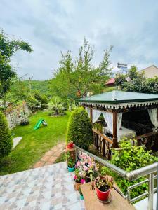 a garden with a gazebo and some plants at Greenland Villa Premium 61 in Trabzon