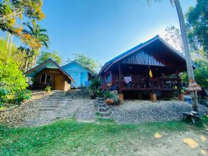 a group of buildings with trees and a building at Adventure Point Resort By Sali in Kaeng Krachan
