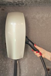 a woman with red nail polish holding a white appliance at Hotel Capri 3 Stelle SUPERIOR in Lido di Jesolo