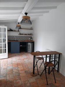 a kitchen with a table and chairs in a room at Studio Versailles Woods in Jouy-en-Josas
