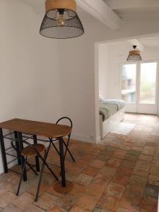 a room with a table and a bed with a window at Studio Versailles Woods in Jouy-en-Josas