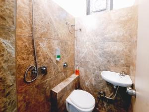 a bathroom with a shower and a toilet and a sink at Hotel Nova Pride in Rajkot +86 photos