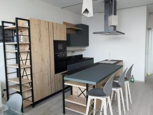 a kitchen with a table and chairs in a room at Palase GC 141 in Palasë