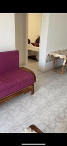 a living room with a purple couch and a table at شاليه مرسي مطروح قرية السعودية in Marsa Matruh