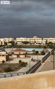 a view of a beach with buildings in the background at شاليه مرسي مطروح قرية السعودية in Marsa Matruh