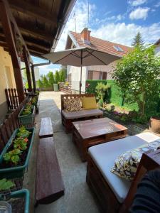 an outdoor patio with benches and an umbrella at Surčin Centar apartment in Surčin