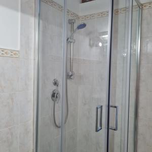 a shower with a glass door and a shower at Gate 25 in San Giovanni Teatino +20 photos