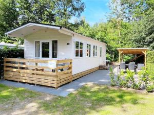 a tiny house with a porch and a gazebo at Chalet Pallegarste 125 in Mariënberg