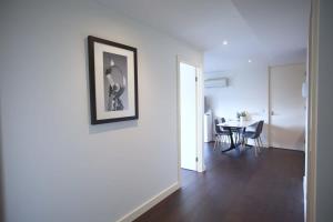 a living room with a table and a picture on the wall at Chic Short Stay Retreat at Doncaster in Doncaster