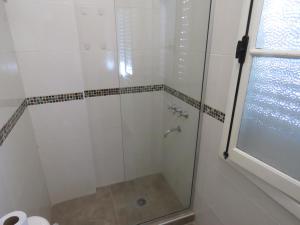 a shower with a glass door in a bathroom at Ana Rent lll in Boulogne