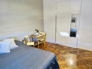 a bedroom with a bed and a small table at Ana Rent lll in Boulogne