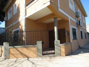a building with a gate on the side of it at Ana Rent lll Moderno departamento ,San Isidro punto medio Tigre River y Tecnopolis in Boulogne