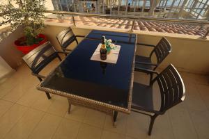 a table and chairs on a balcony with a table at Apartments Milanović in Herceg-Novi
