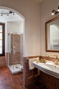 a bathroom with a tub and a sink and a shower at Abbadia San Giorgio in Moneglia