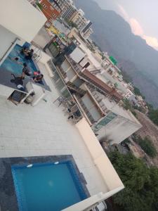 - une vue sur la piscine située à côté d'un bâtiment dans l'établissement Amigo Rooms, à Rishikesh