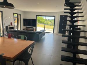 a living room with a spiral staircase in a living room at Villa privée piscine en Provence in Rougiers