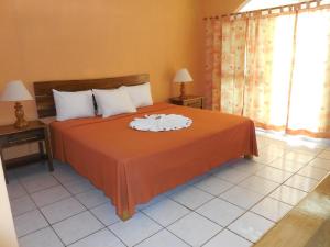 a bedroom with a bed with two towels on it at home sweet home resort in Negril