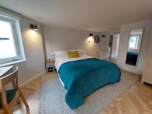 1 dormitorio con 1 cama con manta azul en The Undercroft - central Leamington, en Leamington Spa