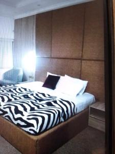 a bed with a zebra print headboard in a room at N.V HOTEL AND RESORT BEACH view in Lagos