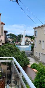 a sailboat on the water with a boat in the distance at Villa L'Amiraute in Agde