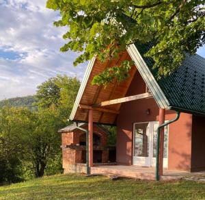 a small brick house with a window and a tree at Weekend House Sunset in Zapoljak
