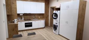 a kitchen with white appliances and a white refrigerator at Ground Floor Rooms in Łomża