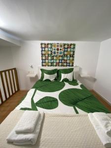 um quarto com uma cama grande com folhas verdes em Estudio Deluxe Hercules em Sevilha