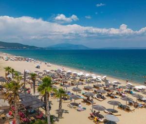 a beach with many umbrellas and crowds of people at Suzy's nest room in Asprovalta
