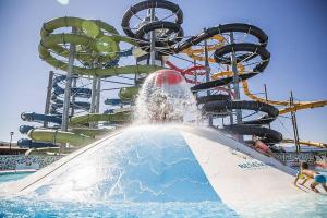 a water park with a water slide in the water at Apartmány LehotSKI Guest House in Pavčina Lehota