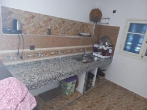 a kitchen counter with a sink and a window at خاص in Dar Hamida