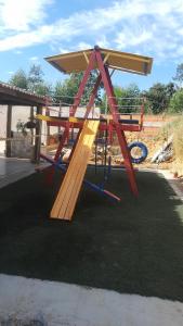 un parque infantil con una estructura de madera en el césped en Cantinho da Milla, en Itu