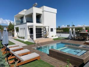 a villa with a swimming pool and a house at Villa Gleandra in Laganas