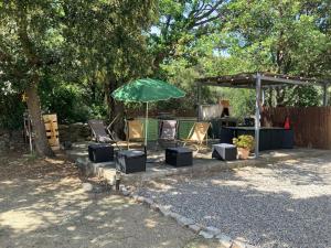 a group of chairs and an umbrella and a table at U FARNIENTE in Patrimonio