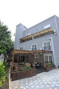 an external view of a building with a patio at Toprak City Hotel Antalya in Antalya