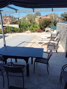 a group of picnic tables and chairs under a canopy at Le Domaine De Marie in Palasca
