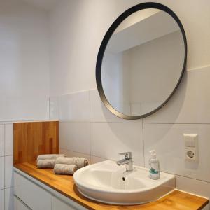 a bathroom with a sink and a mirror at NORA One in Traben-Trarbach +14 photos