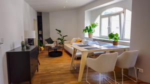 a living room with a table and a couch at NORA One in Traben-Trarbach